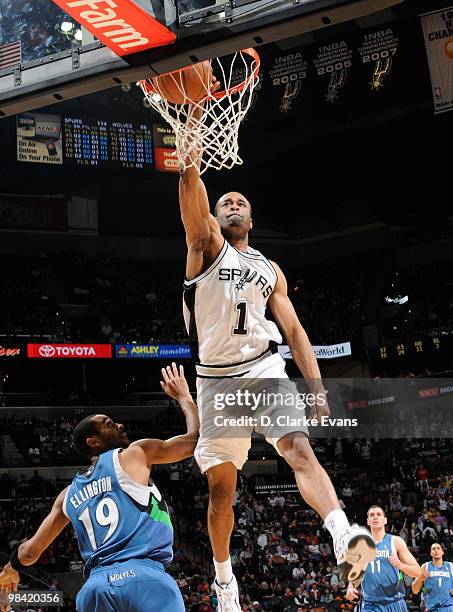 Malik Hairston of the San Antonio Spurs dunks over Wayne Ellington of the Minnesota Timberwolves on April 12, 2010 at the AT&T Center in San Antonio,...