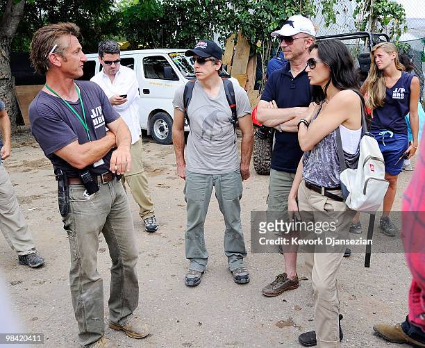 Actor Sean Penn speaks to actors Ben Stiller , Demi Moore, and Director-Producer Paul Haggis look on during a visit at a camp for internally...