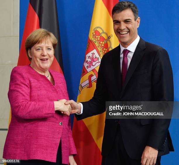 German Chancellor Angela Merkel and Spanish Prime Minister Pedro Sanchez shake hands after a press conference at the Chancellery on June 26, 2018 in...