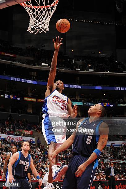 Travis Outlaw of the Los Angeles Clippers puts up a shot against Shawn Marion of the Dallas Mavericks at Staples Center on April 12, 2010 in Los...