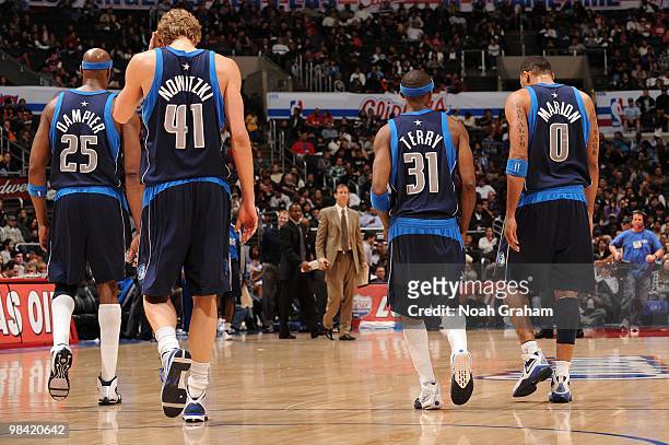 Erick Dampier, Dirk Nowitzki, Jason Terry, and Shawn Marion of the Dallas Mavericks walk to the bench during a break in the action of their game...