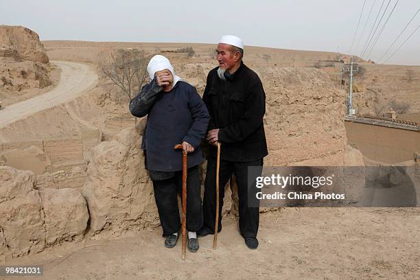 Farmwife wipes her eyes in her yard on March 14, 2010 in Xihaigu, Tongxin County of Ningxia Hui Autonomous Region, north China. Xihaigu is the...