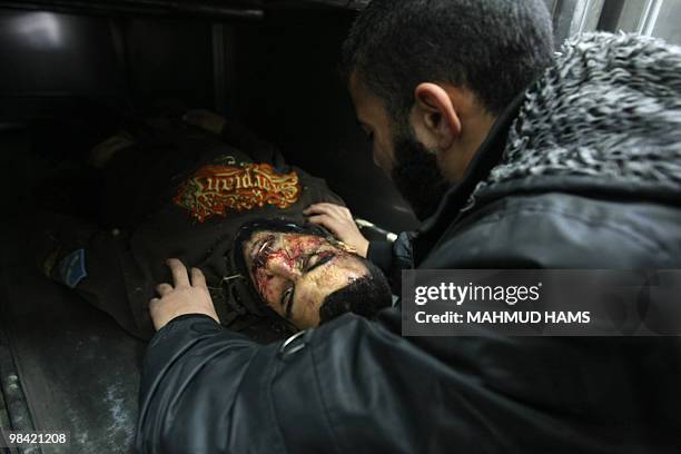 Relative of Palestinian Islamic Jihad militant Marwan al-Jarba mourns over his body at the mortuary of Al-Aqsa hospital in Deir al-Balah, central...