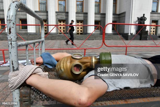 An activist performs in front of the Ukrainian Parliament in Kiev on June 26 during an action against tortures on the International day in support of...