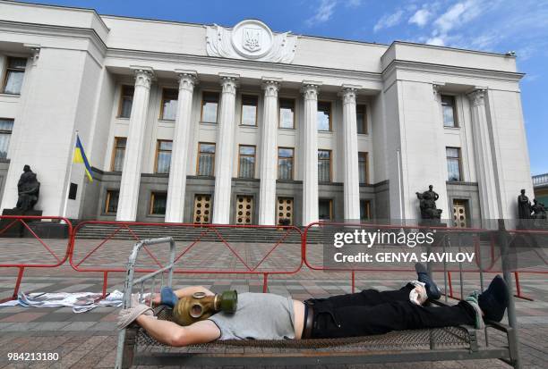 An activist performs in front of the Ukrainian Parliament in Kiev on June 26 during an action against tortures on the International day in support of...