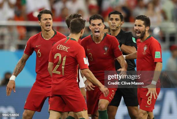 Portugal players react and Cedric receives a yellow card from Referee Enrique Caceres during the 2018 FIFA World Cup Russia group B match between...