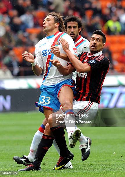 Ciro Capuano of Catania competes with Marco Borriello of Milan during the Serie A match between AC Milan and Catania Calcio at Stadio Giuseppe Meazza...