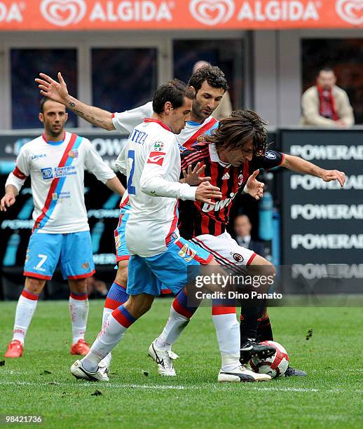 Alessandro Potenza and Gennaro Delvecchio of Catania battles for the ball with Andrea Pirlo of Milan during the Serie A match between AC Milan and...