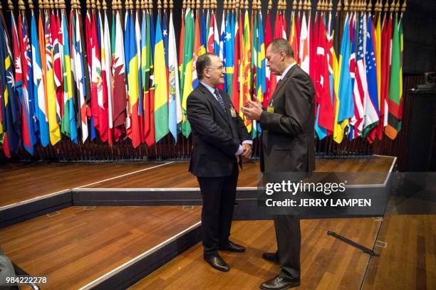 The ambassador of Morocco Abdelouahab Bellouki speaks with Russian ambassador Alexander Sjoelgin at the beginning of an extraordinary session of...