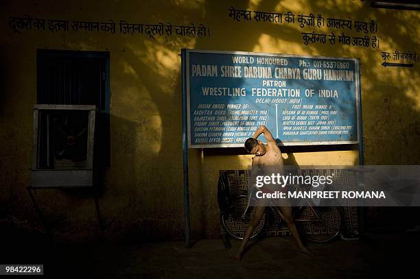 To go with AFP story by Kuldip Lal: WRESTLING-IND-CGAMES-2010 An Indian wrestler stretches for a training session at Guru Hanuman Akhara in New Delhi...