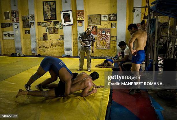 To go with AFP story by Kuldip Lal: WRESTLING-IND-CGAMES-2010 Indian wrestlers practice during a training session at the Guru Hanuman Akhara in New...