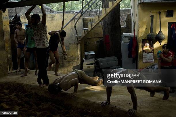 To go with AFP story by Kuldip Lal: WRESTLING-IND-CGAMES-2010 Indian wrestlers exercise during a training session at the Guru Hanuman Akhara in New...
