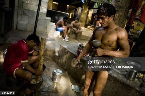 To go with AFP story by Kuldip Lal: WRESTLING-IND-CGAMES-2010 An Indian wrestler exercises during a training session at the Guru Hanuman Akhara in...