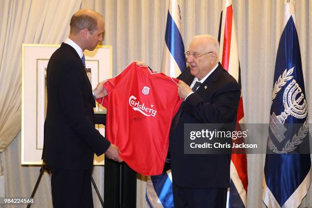 Prince William, Duke of Cambridge presents Israeli President Reuven Rivlin with a Liverpool FC shirt, signed by Steven Gerrard, during his official...