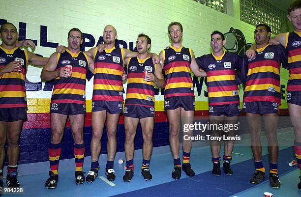 Adelaide players sing the club song after their win in the round 5 match of the AFL between the Adelaide Crows and the Kangaroos played at Football...