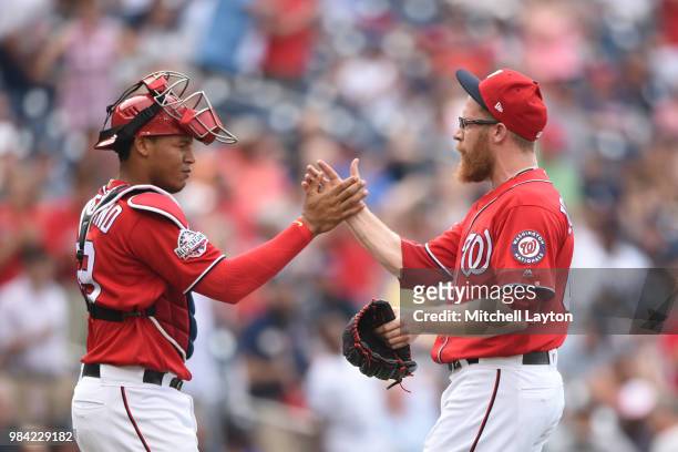 Sean Doolittle of the Washington Nationals celebrates a win with Pedro Severino after game one of a doubleheader against the New York Yankees at...