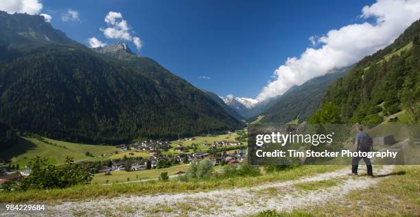 alpine view of the stubai valley in austria with a hiker in the foreground - stubaital stock pictures, royalty-free photos & images