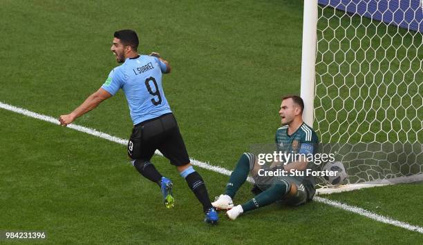 Russia goalkeeper Igor Akinfeev reacts as Luis Suarez of Uruguay celebrates their second goal scored by Diego Laxalt during the 2018 FIFA World Cup...