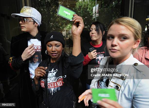 Michael Jackson fans show their court seat tickets outside the Los Angeles Superior Court before Doctor Conrad Murray's second court appearance on an...