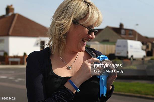 Conservative candidate Caroline Dinenage adjusts her rosette as she campaigns in the constituency of Gosport in Hampshire on April 10, 2010 in...