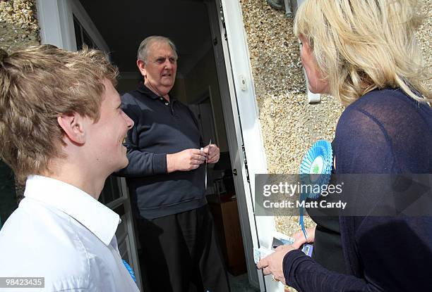 Conservative candidate Caroline Dinenage talks with a potential voter on the doorstep as she campaigns in the constituency of Gosport in Hampshire on...