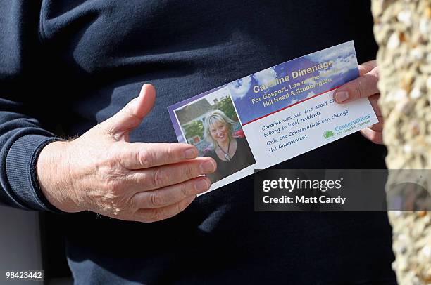 Householder holds a leaflet belonging to Conservative candidate Caroline Dinenage as she campaigns in the constituency of Gosport in Hampshire on...