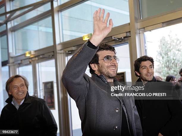 French actor Patrick Bruel waves beside French actor Mathieu Delarive and French director Alexandre Arcady before attending the premiere of their...