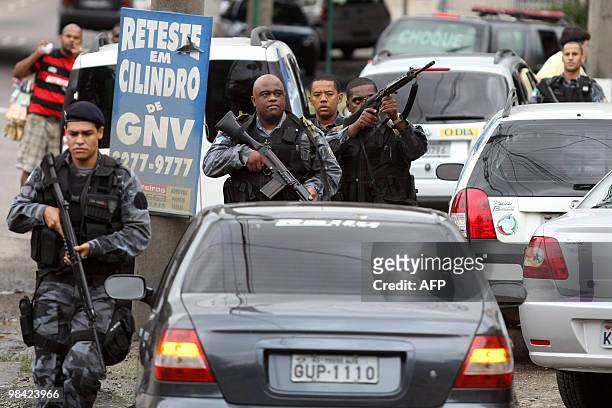 Police personnel from a tactical unit take positions at one of the accesses to the Morro dos Macacos shantytown in Rio de Janeiro, Brazil October 17,...