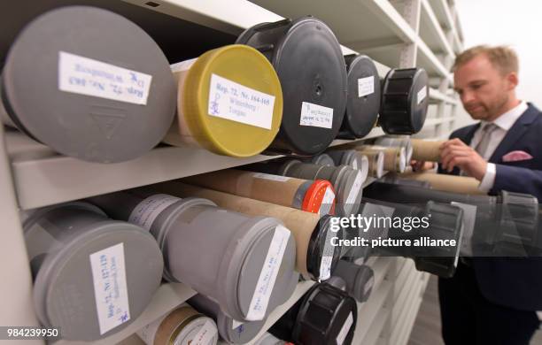 June 2018, Halle/Saale, Germany: Michael Ruprecht, head of the archive of the Martin Luther University in Halle sorts through rolls of rubbings....