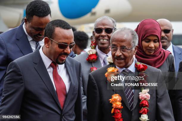 Ethiopia's Prime Minister Abiy Ahmed walks with Eritrea's Foreign minister Osman Saleh Mohammed as Eritrea's delegation arrives for peace talks with...