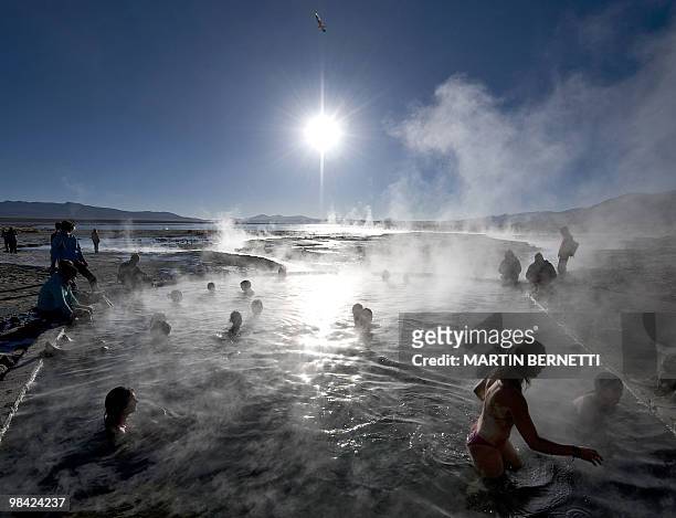 Tourists are seen bathing in hot springs near the small village of Agua Brava, more than 4000 meters above sea level, in the Uyuni salt flats,...