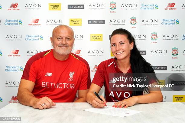 Leighanne Robe poses for a photo with Neil Redfearn, Liverpool Ladies manager after signing for Liverpool Ladies at Anfield on June 25, 2018 in...