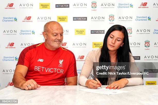 Leighanne Robe poses for a photo with Neil Redfearn, Liverpool Ladies manager after signing for Liverpool Ladies at Anfield on June 25, 2018 in...