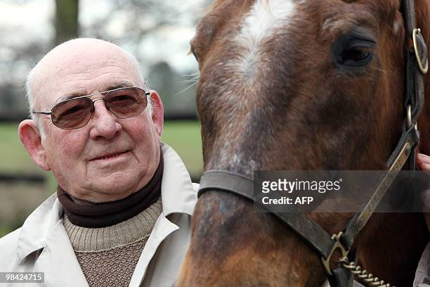 French former horse rider Michel-Marcel Gougeon poses beside Ourasi, a retired French champion racing trotter, on April 07, 2010 in Bayeux in the...