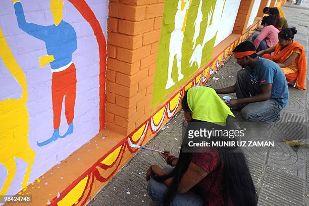 Dhaka University Art Institute students decorate a wall in preparation for the Bengali New Year in Dhaka on April 13, 2010. The Bengali or Bangla...