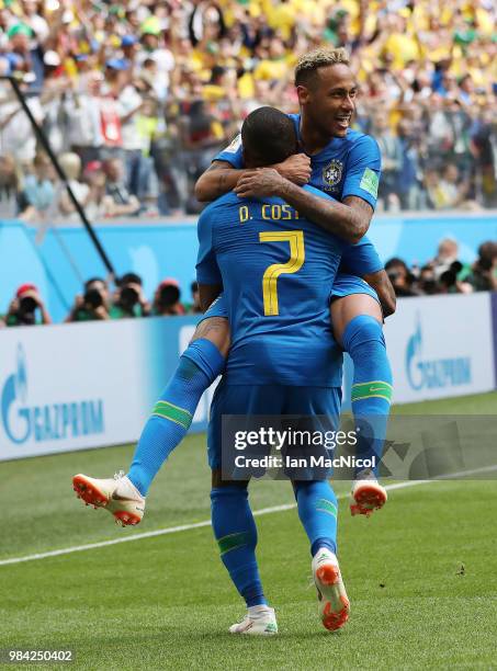 Neymar of Brazil celebrates with Douglas Costa after he scores his team's second goal during the 2018 FIFA World Cup Russia group E match between...