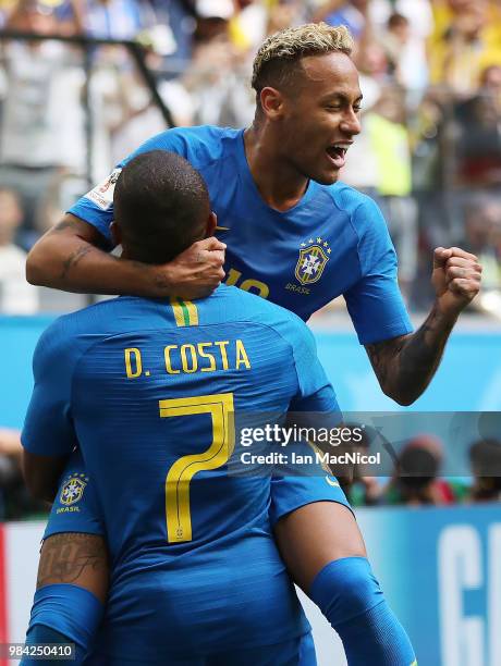 Neymar of Brazil celebrates with Douglas Costa after he scores his team's second goal during the 2018 FIFA World Cup Russia group E match between...