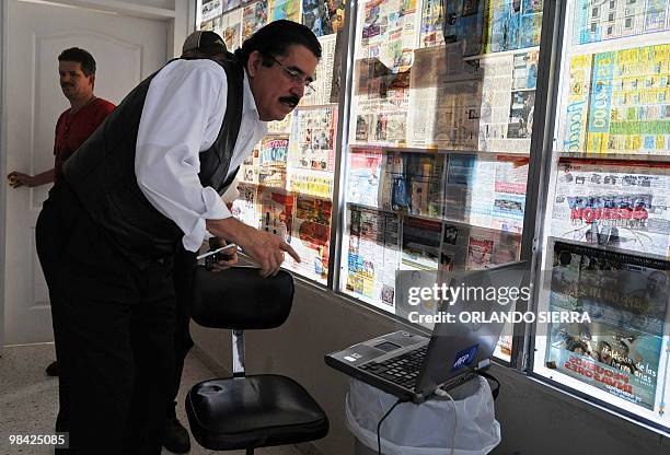 Toppled Honduran President Manuel Zelaya reads the latest news on the AFP laptop inside the Brazilian embassy in Tegucigalpa, on October 12, 2009....