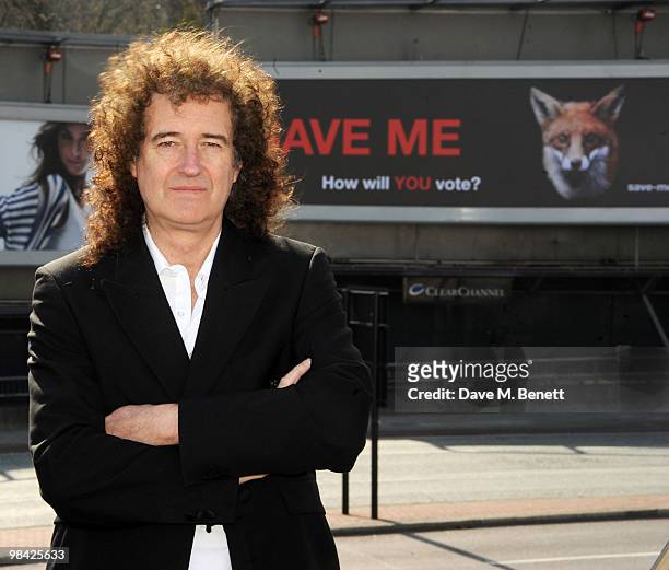 Former musician with the band Queen Brian May poses in front of a giant billboard as he launches the 'Save Me' Campaign in West London on April 13,...