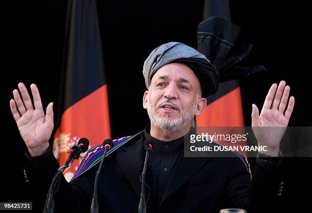In this April 11, 2010 photograph, Afghan President Hamid Karzai addresses local elders in Kunduz, Afghanistan. Karzai urged Taliban insurgents to...