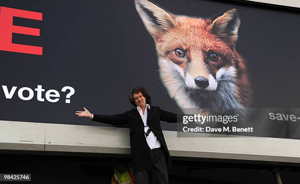 Former musician with the band Queen Brian May poses in front of a giant billboard as he launches the 'Save Me' Campaign in West London on April 13,...