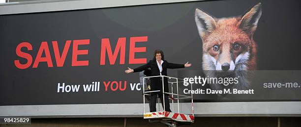 Former musician with the band Queen Brian May poses in front of a giant billboard as he launches the 'Save Me' Campaign in West London on April 13,...