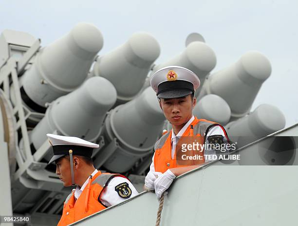 People's Liberation Army Navy sailors stand on the deck of China's Task Force 525 flagship missile frigate Ma'Anshan which saw action in Somalia...