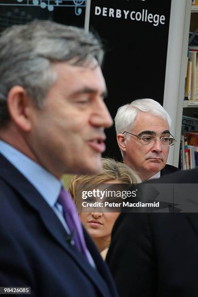Chancellor Alistair Darling listens as Prime Minister Gordon Brown talks to students at Derby College on April 13, 2010 in Derby, England. The...