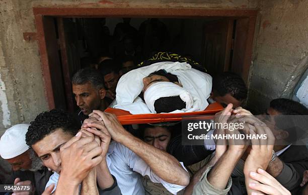 Palestinian mourners carry the body of Islamic Jihad militant Marwan al-Jarba during his funeral at the Bureij refugee camp in the central Gaza Strip...