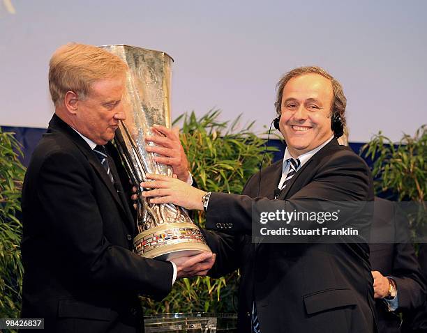 Ole Von Beust, mayor of Hamburg receives the trophy from Michel Platini, president of UEFA during the handover of the UEFA Europa League cup on April...