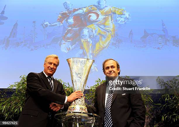 Ole Von Beust, mayor of Hamburg receives the trophy from Michel Platini, president of UEFA during the handover of the UEFA Europa League cup on April...