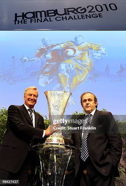 Ole Von Beust, mayor of Hamburg receives the trophy from Michel Platini, president of UEFA during the handover of the UEFA Europa League cup on April...