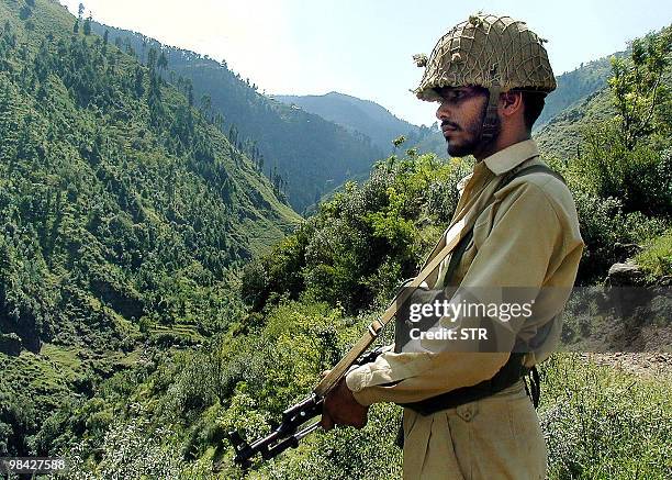 In this picture taken on October 17 A Pakistani trooper patrols at the Line of Control - the defacto border between nuclear capable neighbours...