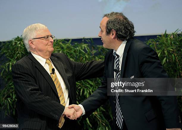 Theo Zwanziger, president of the German Football Association shakes hands with UEFA president Michel Platini during the handover of the UEFA Europa...